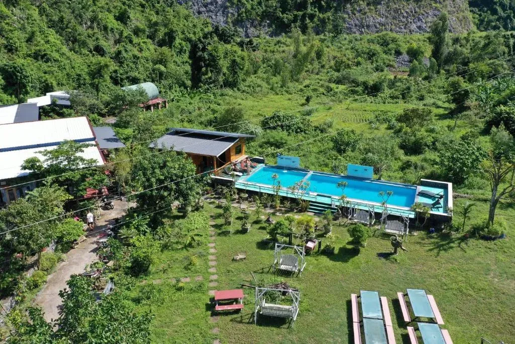 Infinity pool overlooking mountain backdrop at Cat Ba Love House